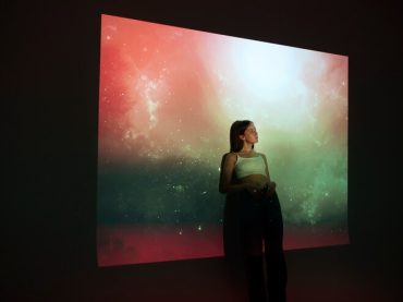 young-woman-standing-universe-texture-projection_23-2149512144